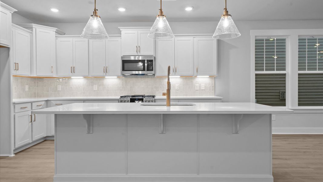 Stylish and efficient kitchen with a modeen island and sleek, current design Stylish and efficient kitchen with a modeen island and sleek, current design