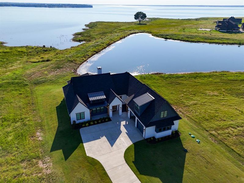 View from above of property with a large body of water View from above of property with a large body of water