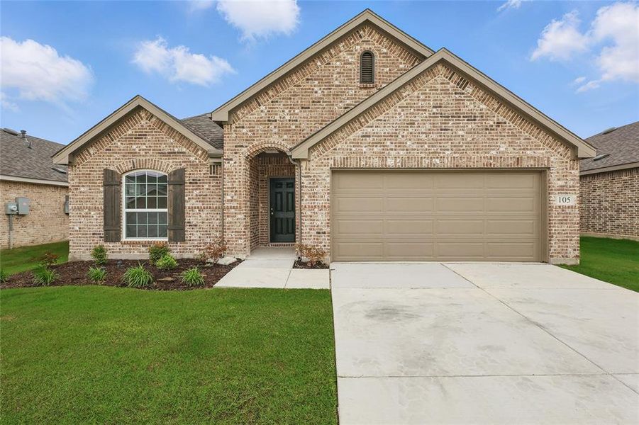 View of front of home with brick siding, a garage, concrete driveway, and a front yard View of front of home with brick siding, a garage, concrete driveway, and a front yard