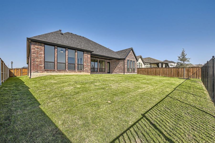 Rear view of house featuring a yard