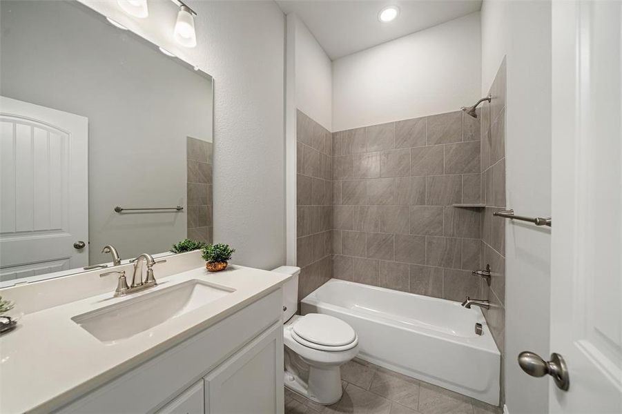 Bathroom featuring shower / bath combination, vanity, and light tile patterned flooring Bathroom featuring shower / bath combination, vanity, and light tile patterned flooring