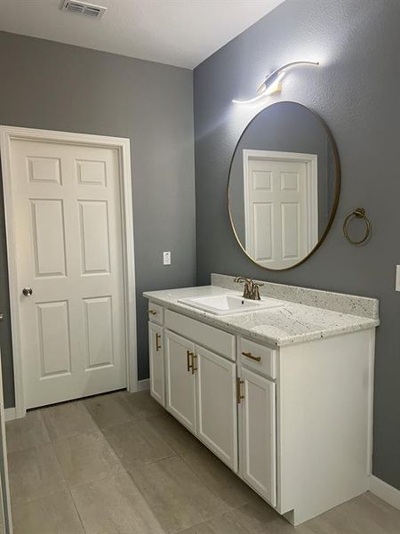 Bathroom with vanity and tile patterned flooring. Bathroom with vanity and tile patterned flooring.