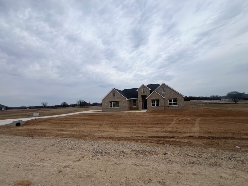Front exterior of a new home in Zion Valley, Poolville, TX, highlighting curb appeal (Image 2).