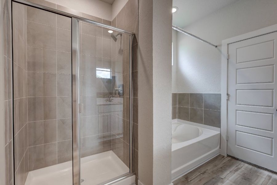 A bathroom with a glass shower. A bathroom with a glass shower.