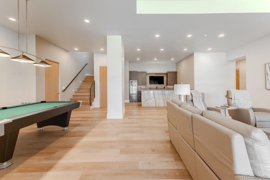 Echoing the main levels refined aesthetic, the lower level’s 12-foot ceilings and elegant finishes create a sophisticated backdrop for leisure and entertaining.