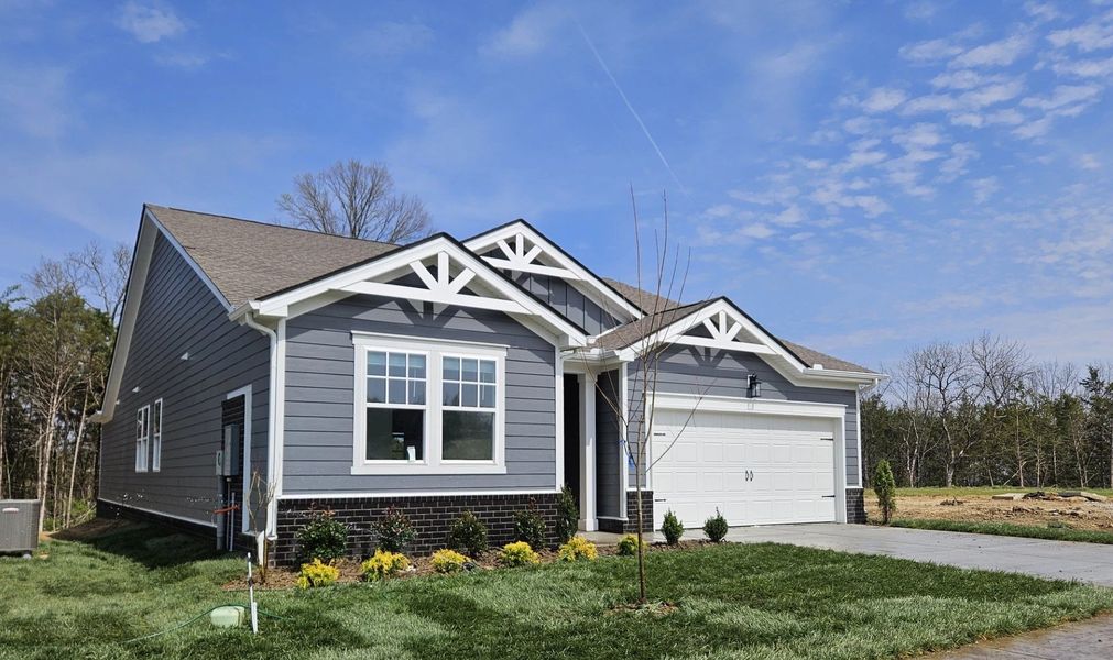 Front exterior of a new home in Cedars of Cane Ridge | 55+ Community, Antioch, TN, highlighting curb appeal (Image 2). Front exterior of a new home in Cedars of Cane Ridge | 55+ Community, Antioch, TN, highlighting curb appeal (Image 2).