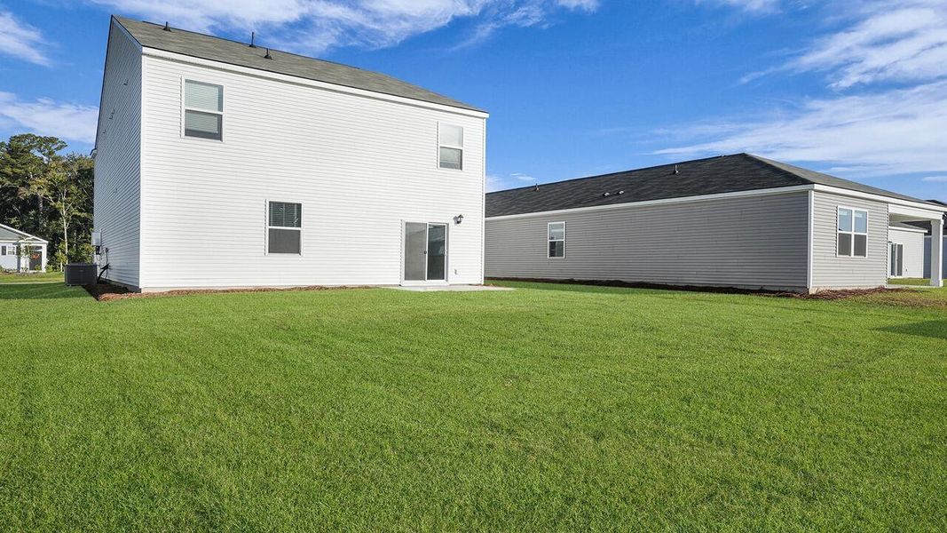 Exterior details and patio area of a home in Pine Hills at Cane Bay, Summerville (Image 21).