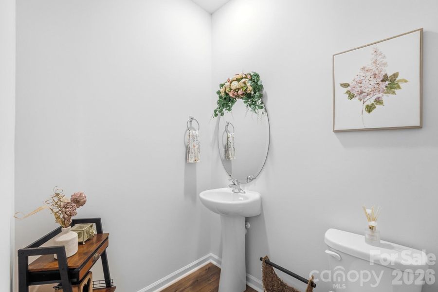 Conveniently located guest powder room with modern finishes. Conveniently located guest powder room with modern finishes.