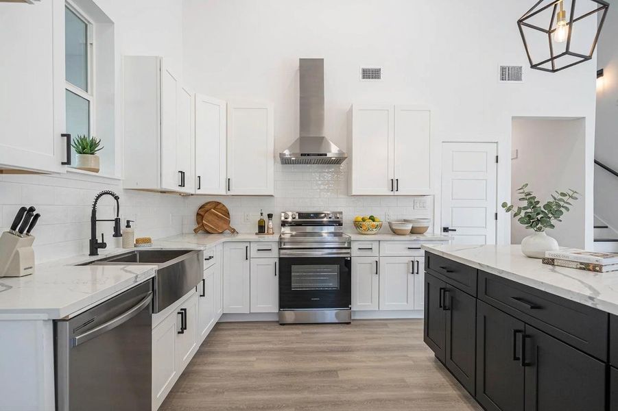 Crisp white cabinetry paired with a dark contrasting island creates architectural depth in this modern space. Crisp white cabinetry paired with a dark contrasting island creates architectural depth in this modern space.