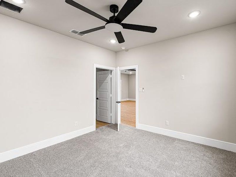 Unfurnished bedroom with carpet floors, ceiling fan, and recessed lighting Unfurnished bedroom with carpet floors, ceiling fan, and recessed lighting