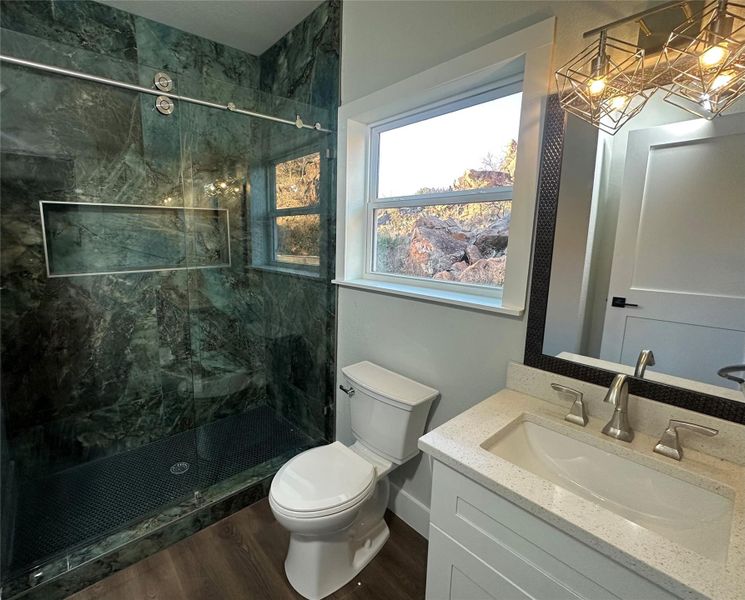 Bathroom featuring vanity, an incredible marble finish shower with frameless glass doors Bathroom featuring vanity, an incredible marble finish shower with frameless glass doors