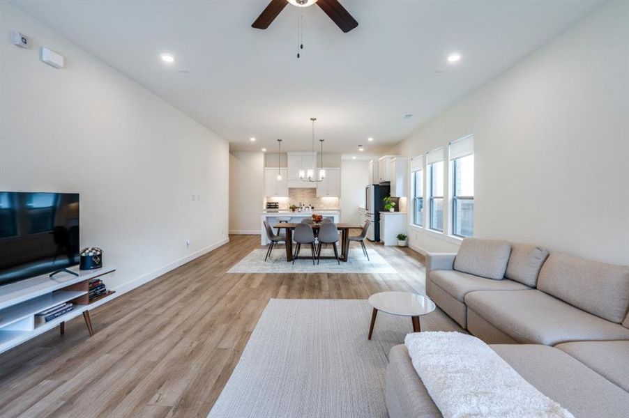 Living room featuring light wood-style floors, recessed lighting, and ceiling fan Living room featuring light wood-style floors, recessed lighting, and ceiling fan