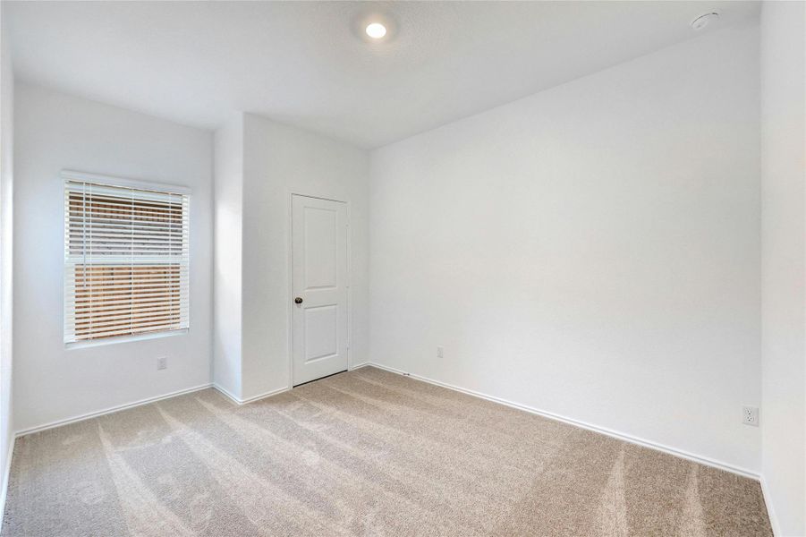 Unfurnished room with light colored carpet and baseboards