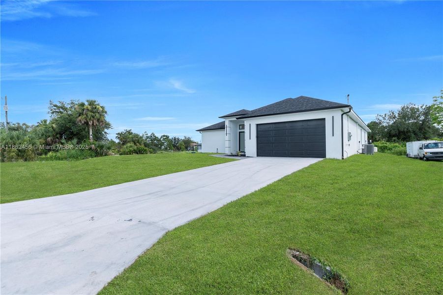 Front exterior of a new home in , Lehigh Acres, FL, highlighting curb appeal (Image 18). Front exterior of a new home in , Lehigh Acres, FL, highlighting curb appeal (Image 18).