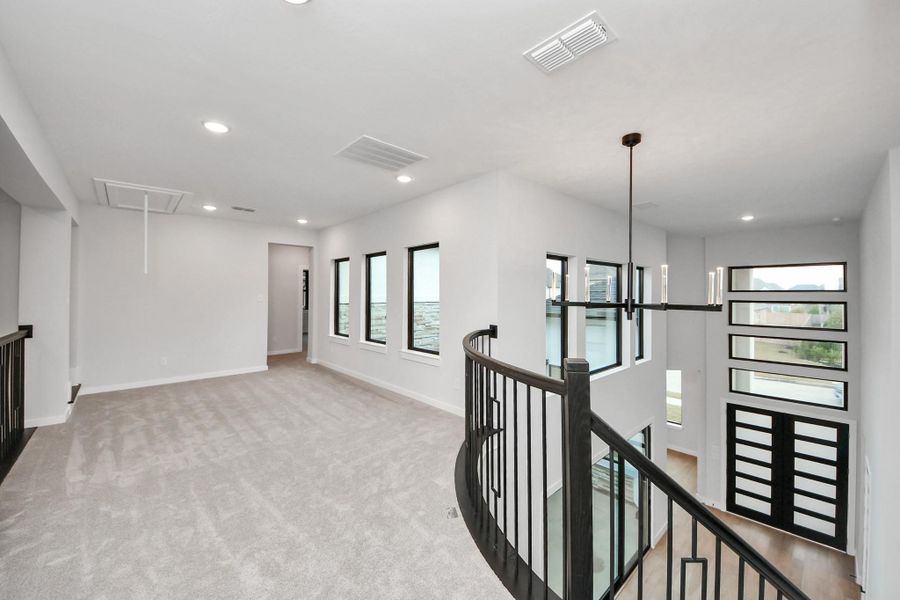 Large open area just over the stairs. To the right are more bedrooms and to the left is an oversized gameroom.