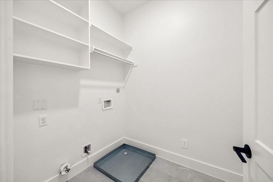 Dedicated utility room designed with additional storage, generous workspace, and everyday convenience in mind.