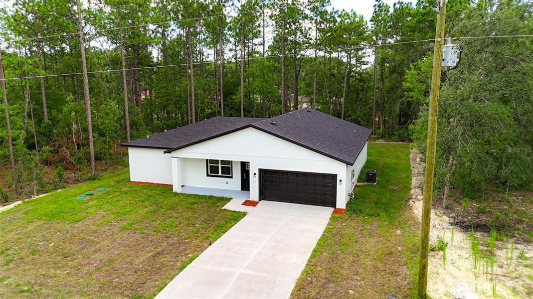Front exterior of a new home in , Citrus Springs, FL, highlighting curb appeal (Image 2). Front exterior of a new home in , Citrus Springs, FL, highlighting curb appeal (Image 2).