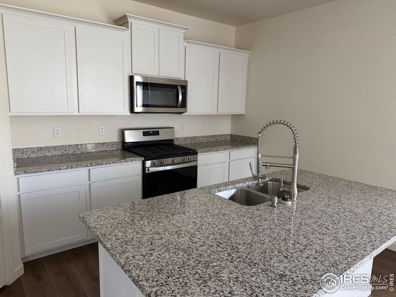 Kitchen with granite countertop and island Kitchen with granite countertop and island