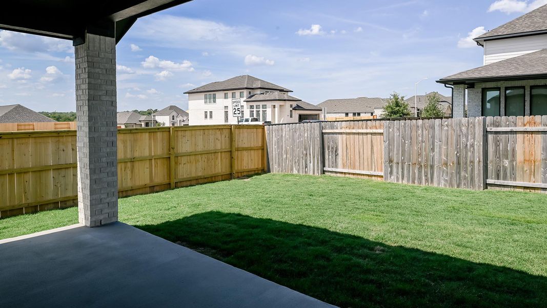 Fenced backyard featuring a patio and a residential view Fenced backyard featuring a patio and a residential view