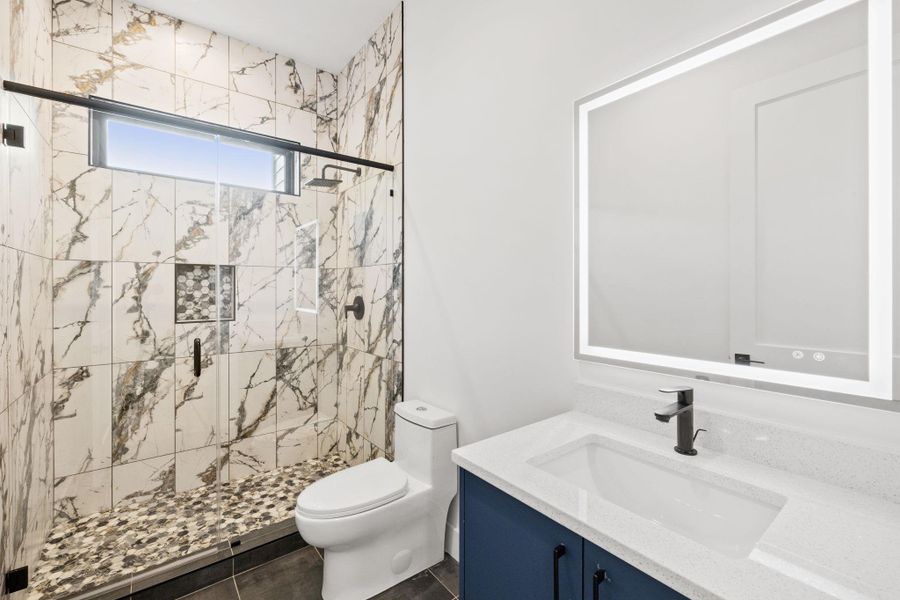 Full bathroom downstairs adjacent to bedroom