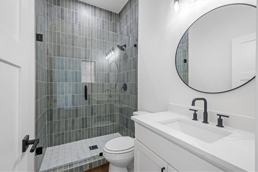 Bathroom featuring vanity and a shower stall Bathroom featuring vanity and a shower stall