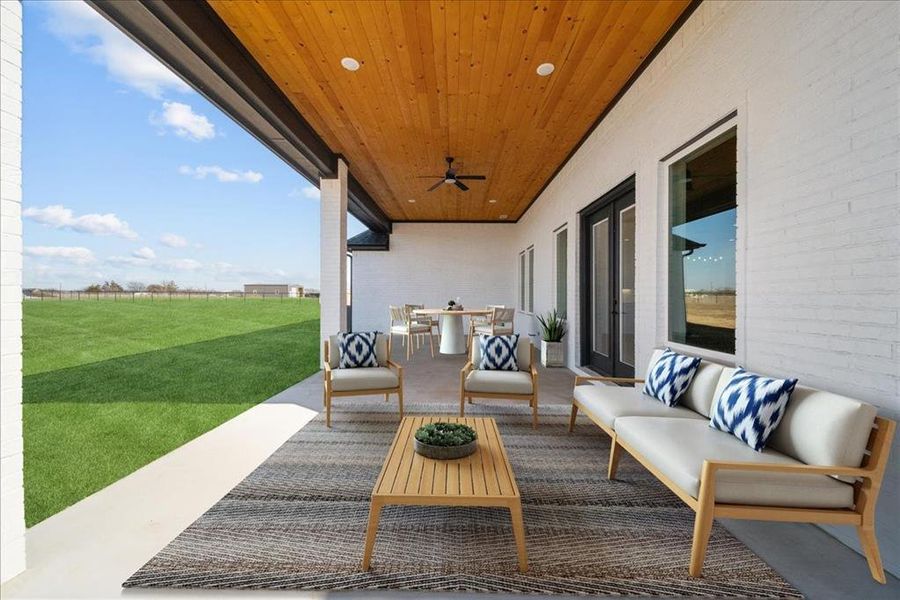 View of patio featuring an outdoor living space and ceiling fan