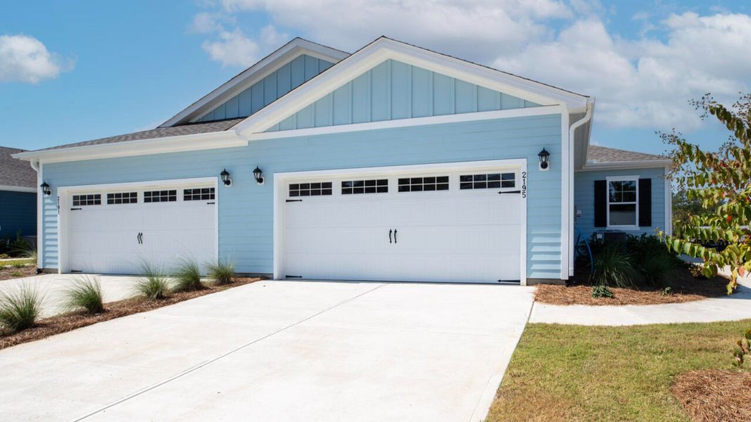 Front exterior of a new home in Indigo Preserve Townhomes, Leland, NC, highlighting curb appeal (Image 1).