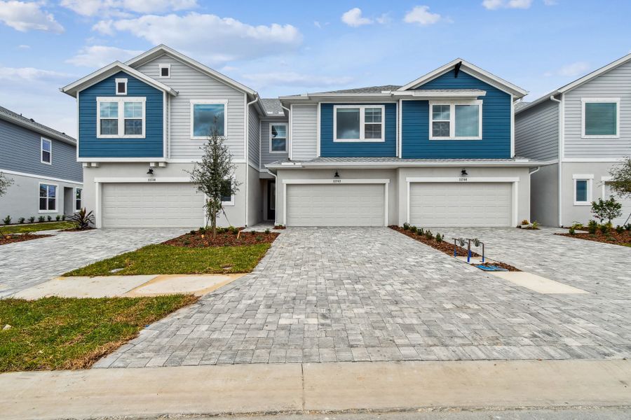 Front exterior of a new home in North River Ranch – Townhomes, Parrish, FL, highlighting curb appeal (Image 2). Front exterior of a new home in North River Ranch – Townhomes, Parrish, FL, highlighting curb appeal (Image 2).