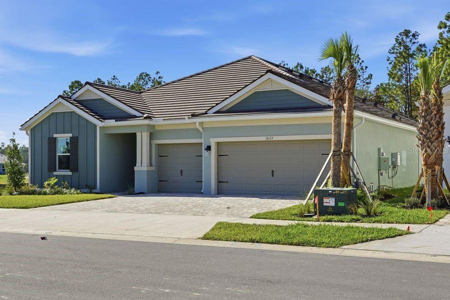 Front exterior of a new home in Hammock at Two Rivers, Zephyrhills, FL, highlighting curb appeal (Image 1).