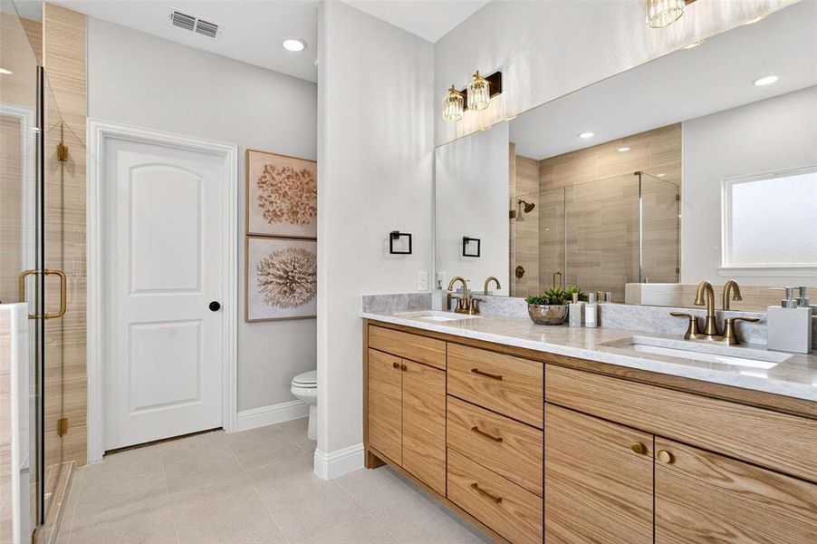 Full bath featuring double vanity, recessed lighting, a stall shower, and light tile patterned floors