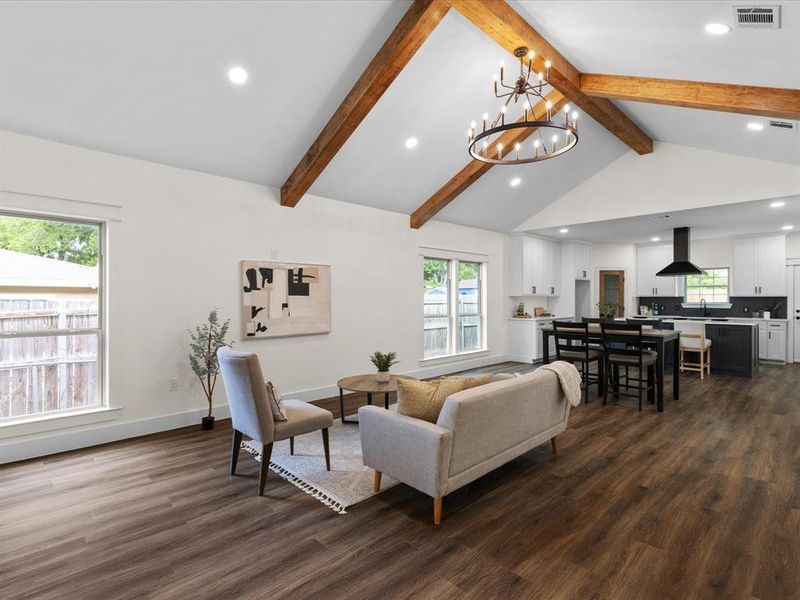 Living room featuring suspended lighting and dark wood finished floors