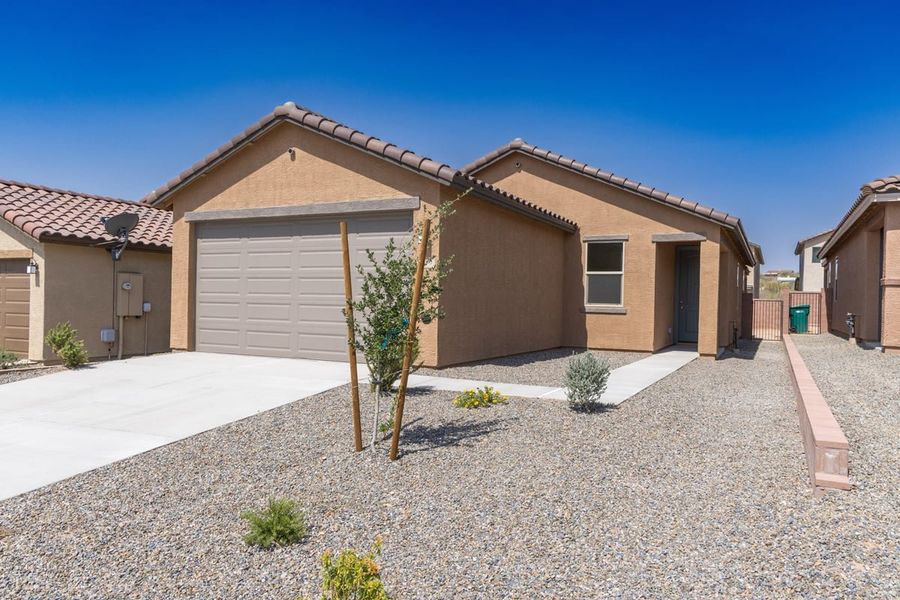 Front exterior of a new home in Vista Del Oro Reserve, Tucson, AZ, highlighting curb appeal (Image 1). Front exterior of a new home in Vista Del Oro Reserve, Tucson, AZ, highlighting curb appeal (Image 1).