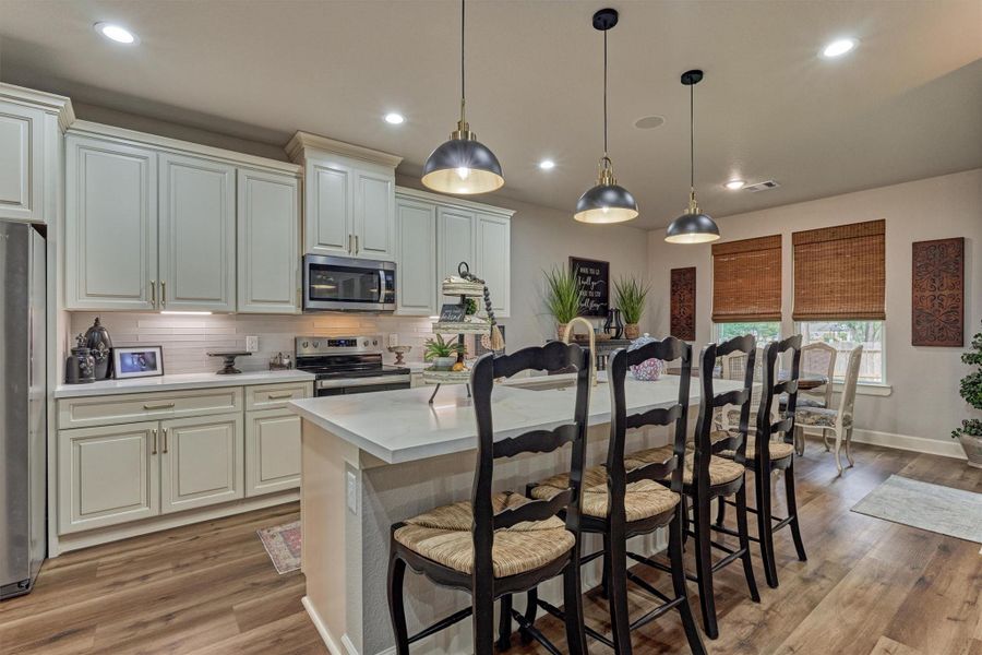 Show stopping gourmet kitchen with quartz countertops, custom soft-close cabinetry/drawers, under-cabinet lighting, wood plank flooring, and upgraded designer fixtures. Show stopping gourmet kitchen with quartz countertops, custom soft-close cabinetry/drawers, under-cabinet lighting, wood plank flooring, and upgraded designer fixtures.