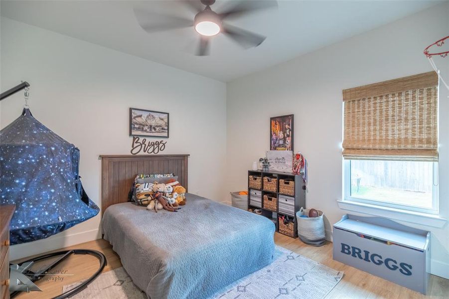 Bedroom with wood finished floors and ceiling fan Bedroom with wood finished floors and ceiling fan