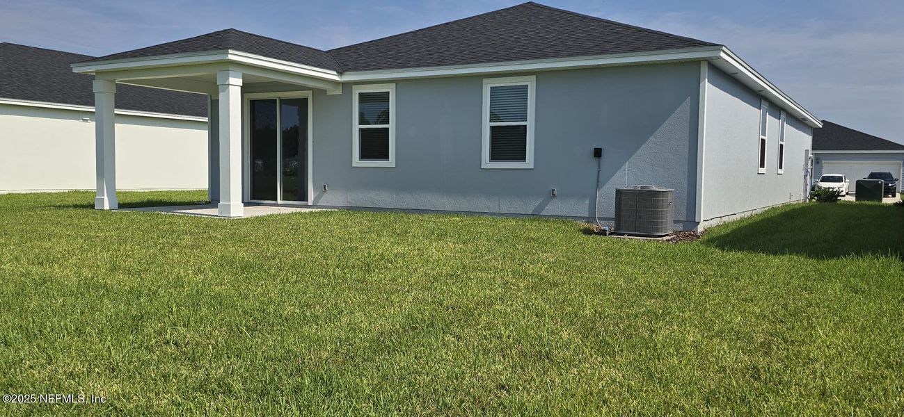Front exterior of a new home in Lakes at Bella Lago - Signature Series, Green Cove Springs, FL, highlighting curb appeal (Image 18).