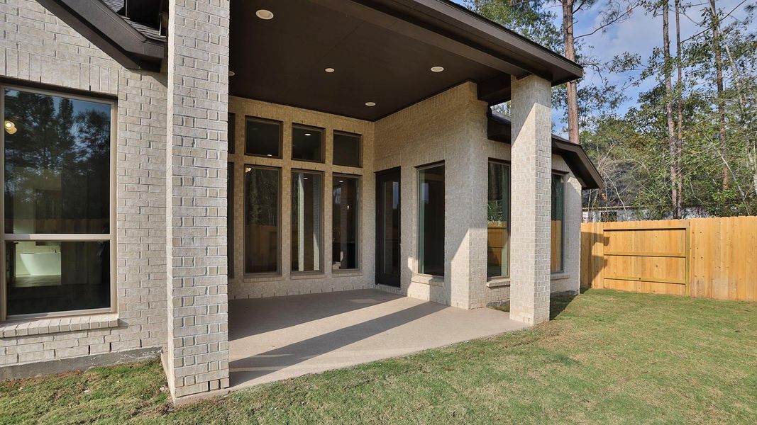 Exterior details and patio area of a home in Woodhavyn 50', Magnolia (Image 4). Exterior details and patio area of a home in Woodhavyn 50', Magnolia (Image 4).