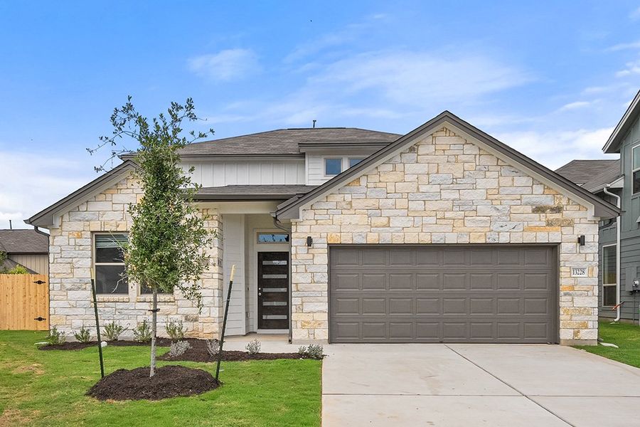 Front exterior of a new home in The Hills of Bear Creek, Manchaca, TX, highlighting curb appeal (Image 23).