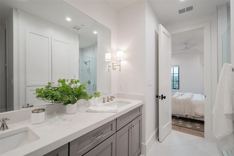 Bathroom with vanity and a shower with door