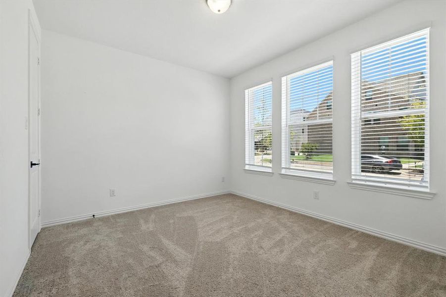 Bedroom on 1st floor. Large windows. Views to the outside and plush carpetting and walk in closet.