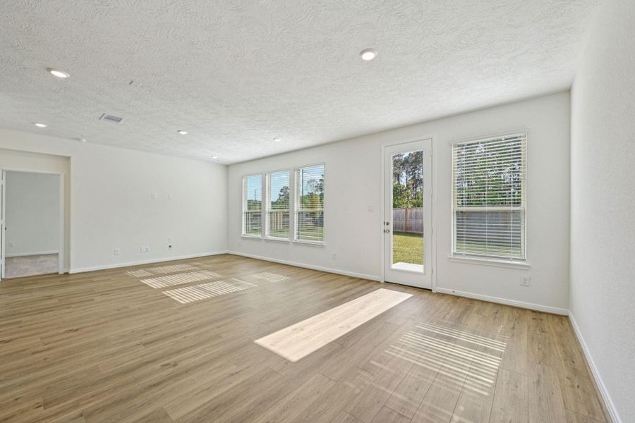 Make memories gathered around the table with your family and friends! This dining room features high ceilings, large window, tile flooring, recessed lighting, and an access door to your extended covered patio and backyard.