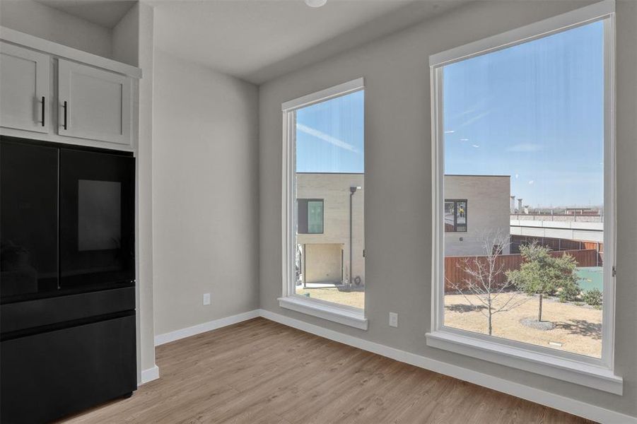 The dining area sits in a bright, airy corner framed by large windows, offering a sophisticated spot for morning coffee or dinner with friends. The dining area sits in a bright, airy corner framed by large windows, offering a sophisticated spot for morning coffee or dinner with friends.