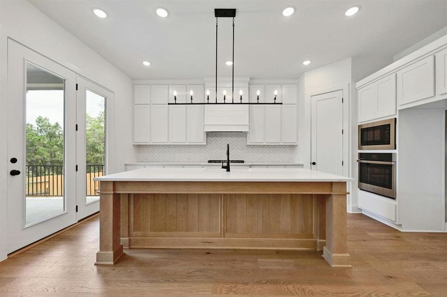 Kitchen with white cabinetry, tasteful backsplash, recessed lighting, pendant lighting, and oven Kitchen with white cabinetry, tasteful backsplash, recessed lighting, pendant lighting, and oven