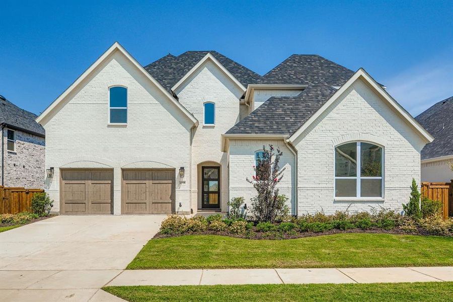 French provincial home featuring concrete driveway, a garage, a shingled roof, and brick siding French provincial home featuring concrete driveway, a garage, a shingled roof, and brick siding
