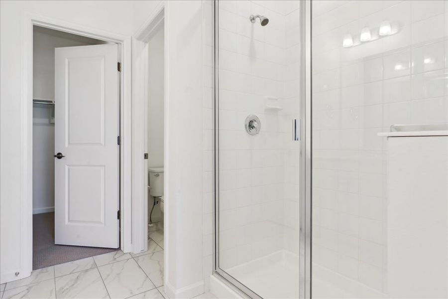 A bathroom with a glass shower.