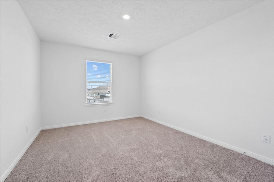 This secondary bedroom offers comfort and style with plush carpeting, neutral paint tones, recessed lighting, a large window with blinds, and a generously sized closet. This secondary bedroom offers comfort and style with plush carpeting, neutral paint tones, recessed lighting, a large window with blinds, and a generously sized closet.