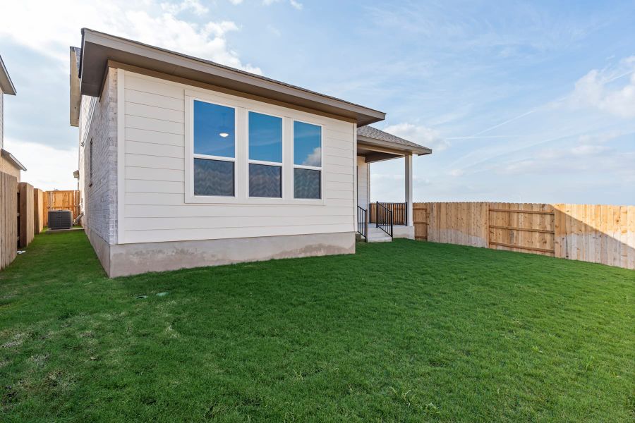Exterior details and patio area of a home in Lariat, Liberty Hill (Image 26).