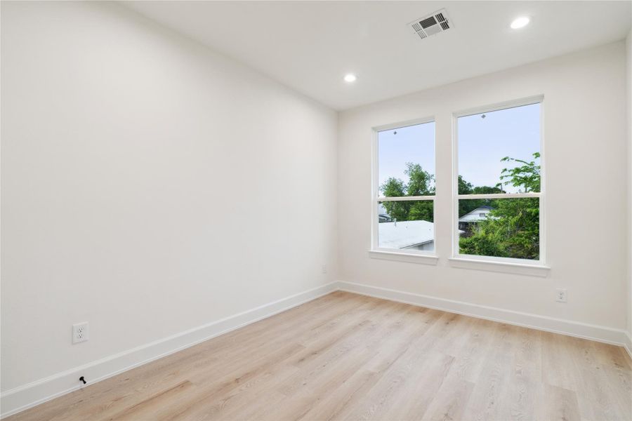 Enjoy an abundance of light even in the third guest bedroom, continuing the theme of oversized windows found throughout the home.