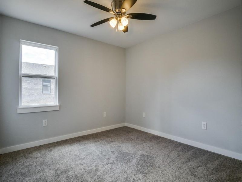 Unfurnished room with carpet flooring and ceiling fan Unfurnished room with carpet flooring and ceiling fan