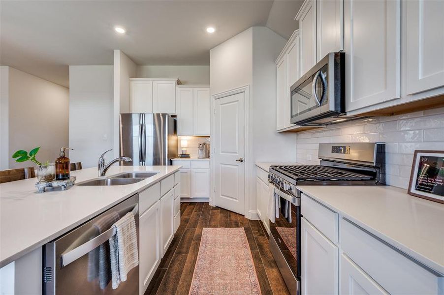 Kitchen with white cabinets, appliances with stainless steel finishes