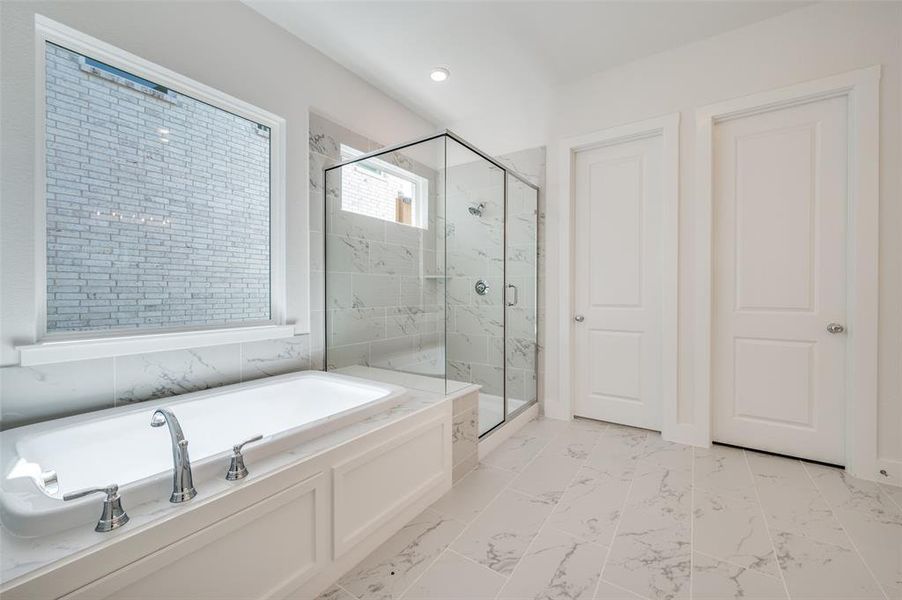 Bathroom featuring plus walk in shower and tile patterned flooring